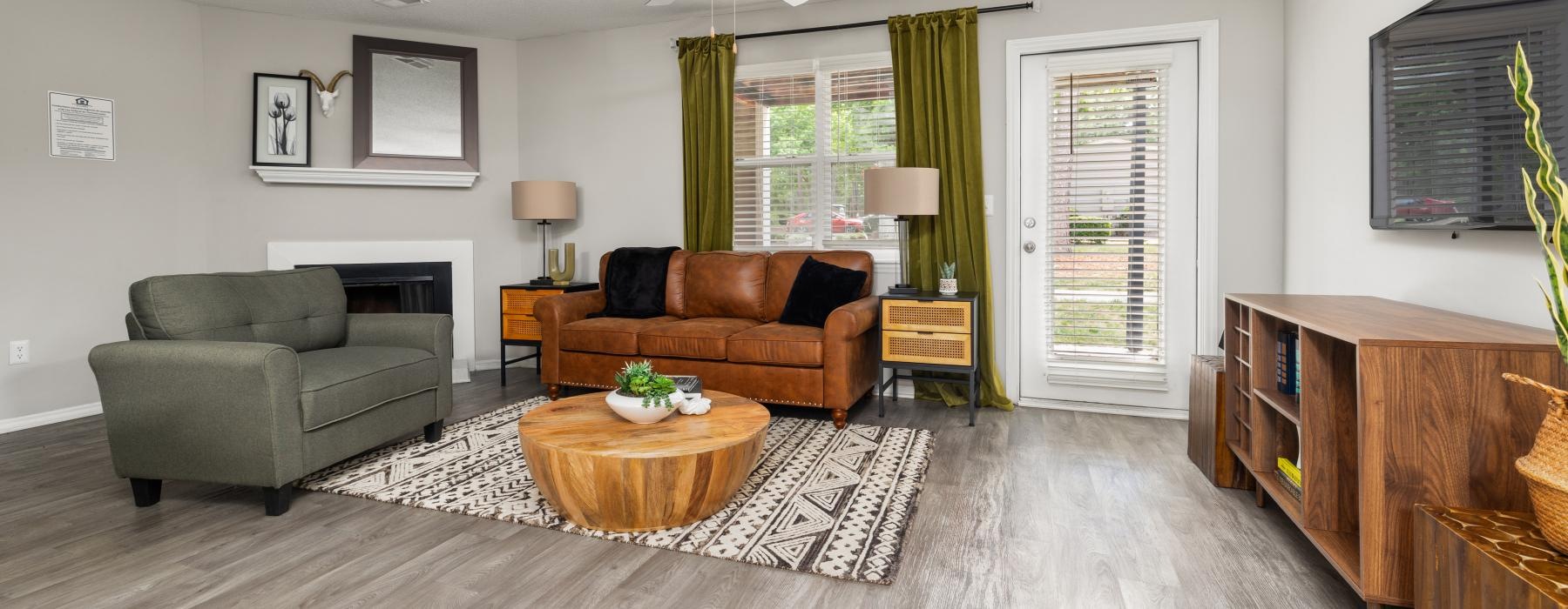 a living room with a large rug couch and tv stand