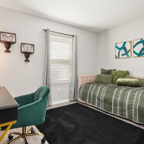 a bedroom with a bed and desk