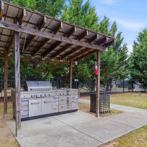 a covered area with a large grill